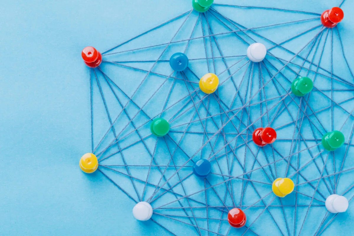 Colourful pins connected by string.